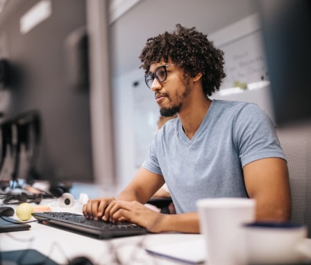 Man typing on computer keyboard