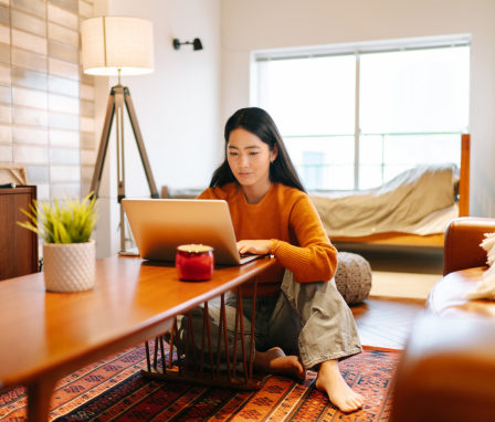 Young woman using laptop comfortably at home