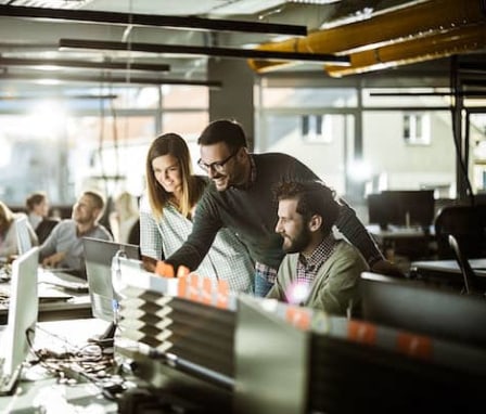 Group of colleagues working together on a computer