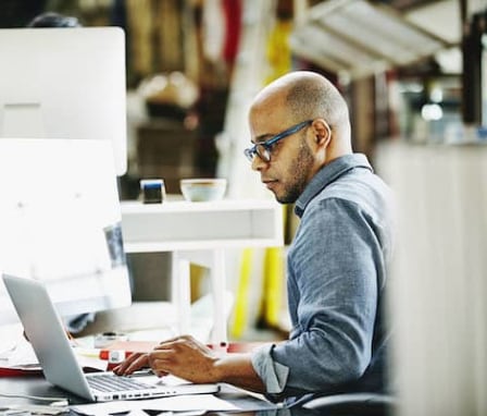 Man working on laptop in office