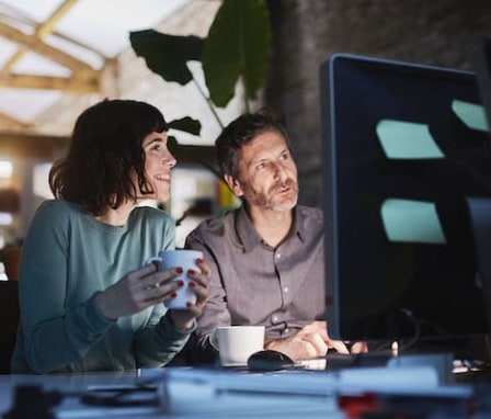 Man and woman working together on a computer