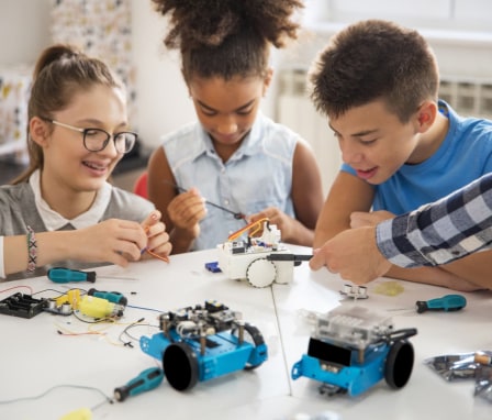 Happy kids building robotic cars