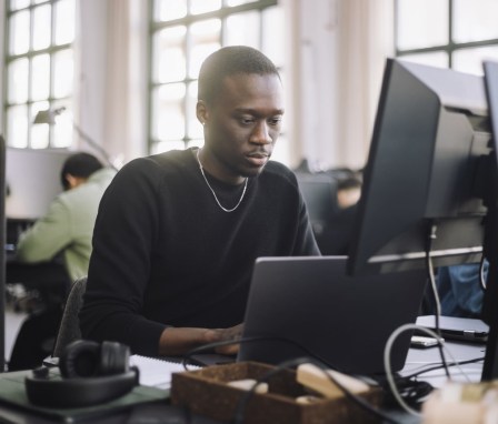 Man typing on desktop computer