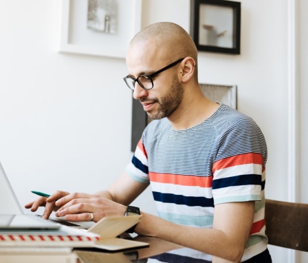 Man sitting in a comfortable office and working on a laptop