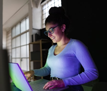 Young student with laptop working at home office